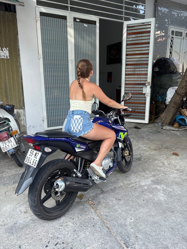 Woman poses with Yamaha motorcycle in Nha Trang