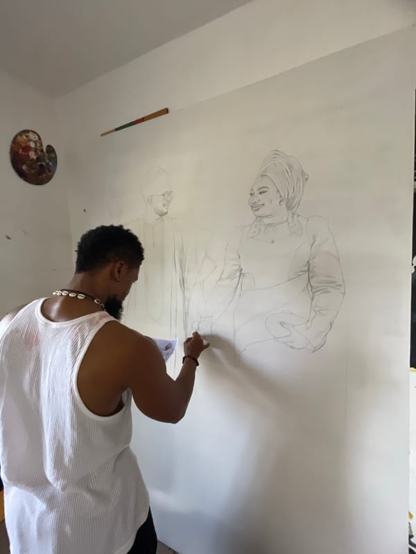 Artist draws figures on paper in Ado, Nigeria