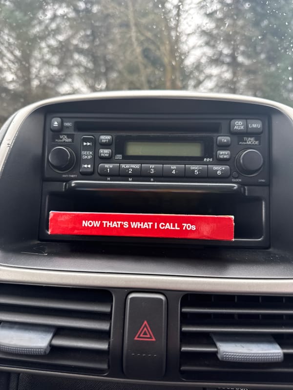 Person rests in car with feet up, radio visible