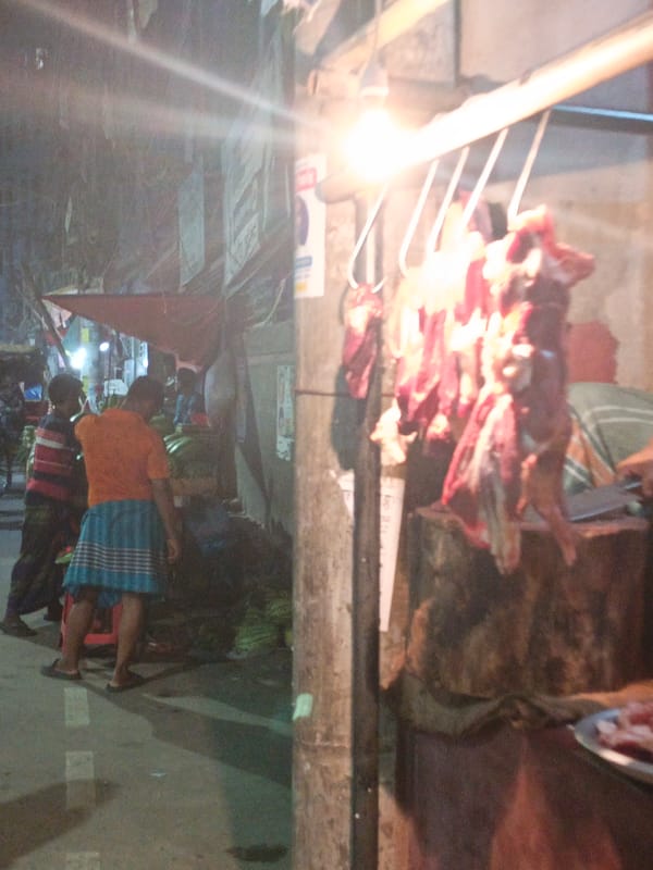 Night market meat stall captured in Dhaka