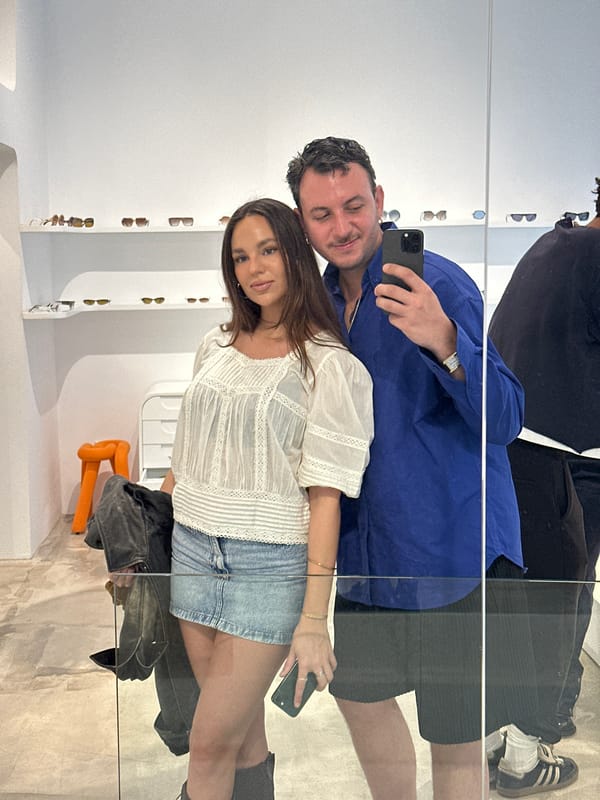 Couple shops for vintage sunglasses in Madrid retail store