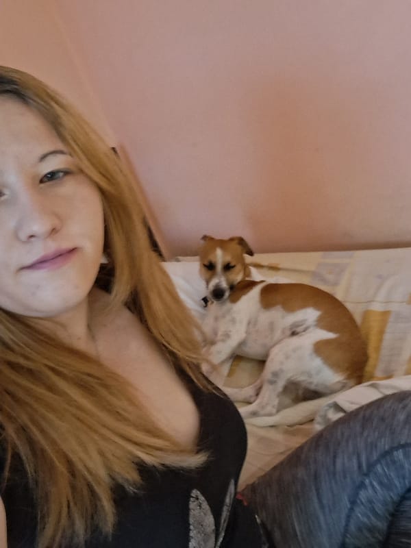 Woman takes early morning selfie with sleeping dog in Bulgaria