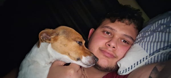 Man and small dog rest together in Varna