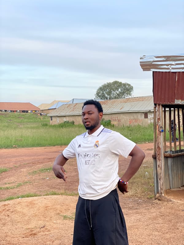 Outdoor barbershop and street life in Durumi, Nigeria