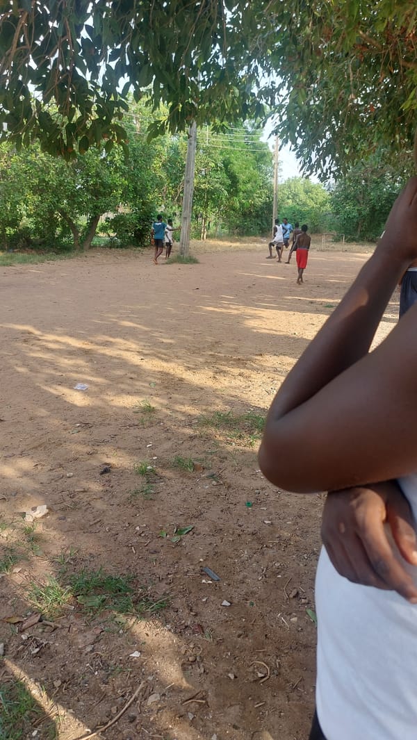 Pickup soccer on a dirt field in New Nyanya, Nigeria