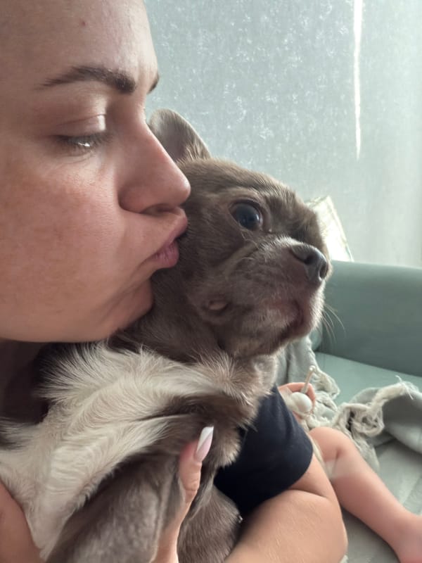 Woman plays with puppy during family time in Votkinsk