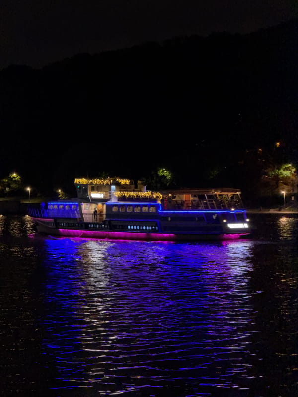 Evening stroll near illuminated passenger ship in Moscow