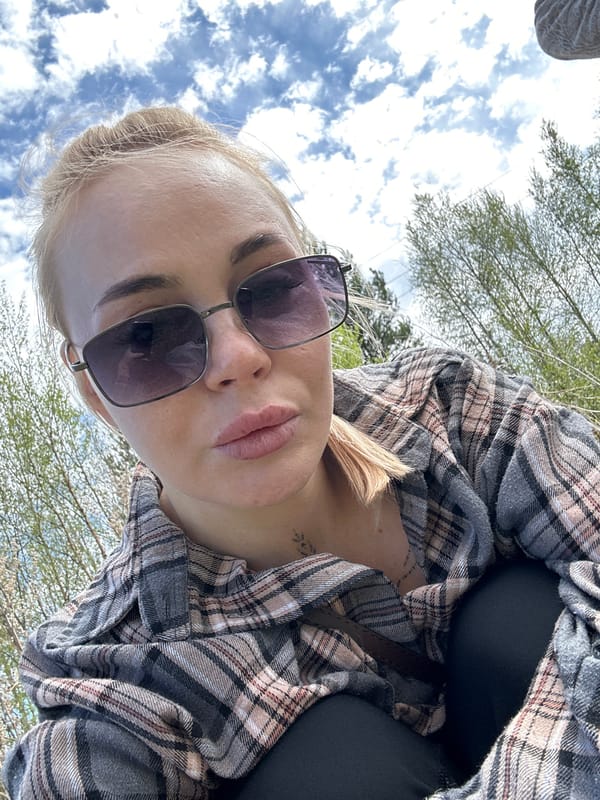 Woman photographs herself with dog in Vysokiy, Russia