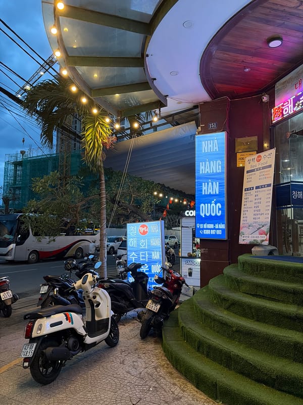 Đà Nẵng street life at dusk — food stalls, hotels, and rising skyline