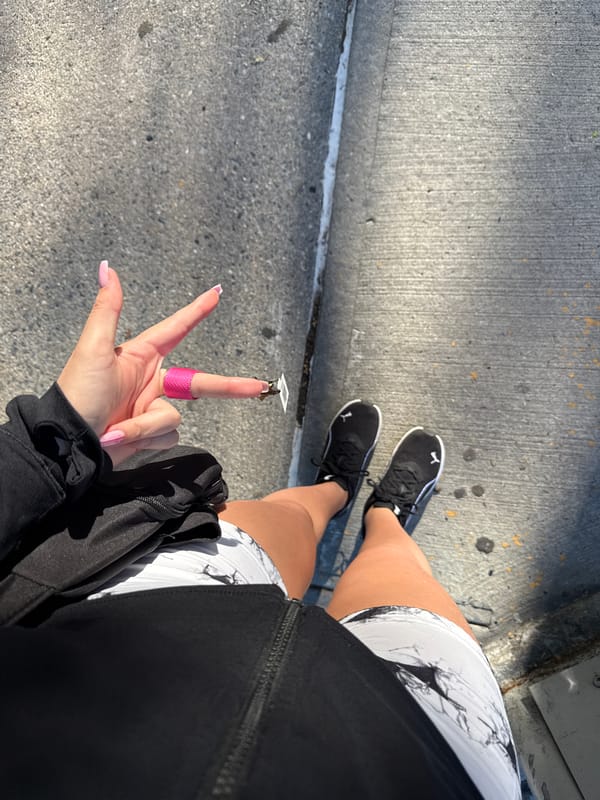 Sidewalk pause at a sunny Bronx intersection, June 2026