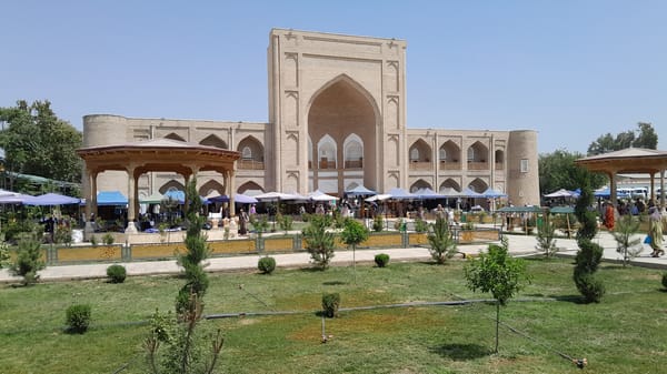 Street market buzzing outside Denov's historic Juma Mosque complex