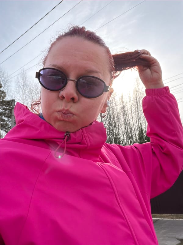 Woman takes selfies on overcast street in Chaikovsky, Russia