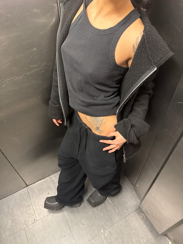 Tattooed individual in black clothing observed lying in London