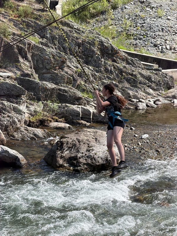 Ziplining over a rocky river at a Chemal adventure park