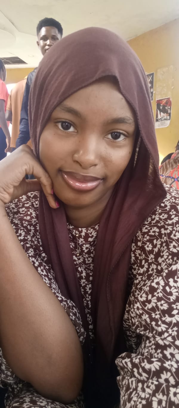 Young women photograph together at Keffi institution morning gathering