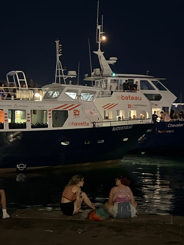 Métropole ferry docked at Marseille's illuminated Old Port at night