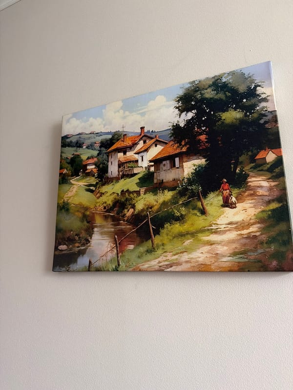 Crooked landscape painting observed on textured wall