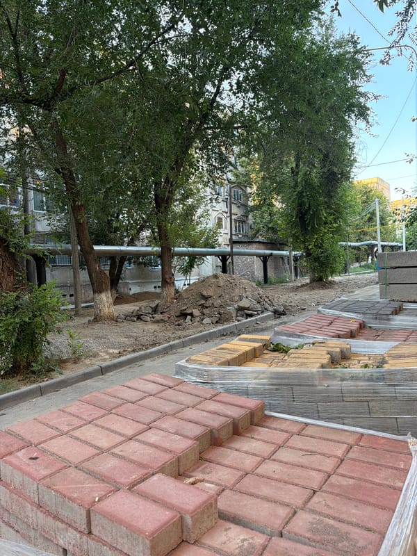 Shymkent street under active roadwork and landscaping renovation