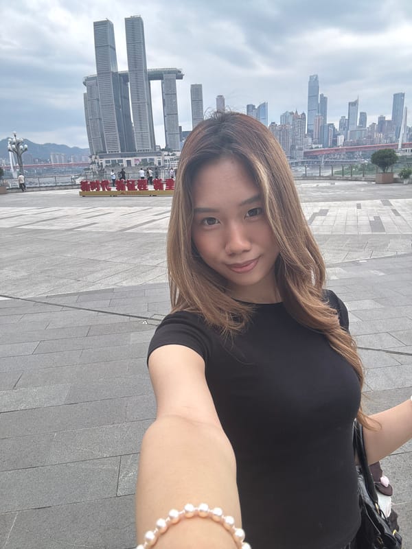 Woman takes selfies at Chongqing observation deck with city backdrop