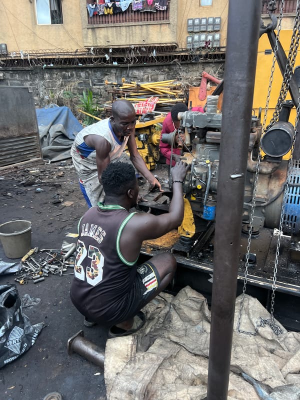 Generator repair work underway at outdoor workshop in Obosi, Nigeria