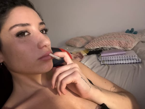 Woman smoking cigarette on bed in Buenos Aires