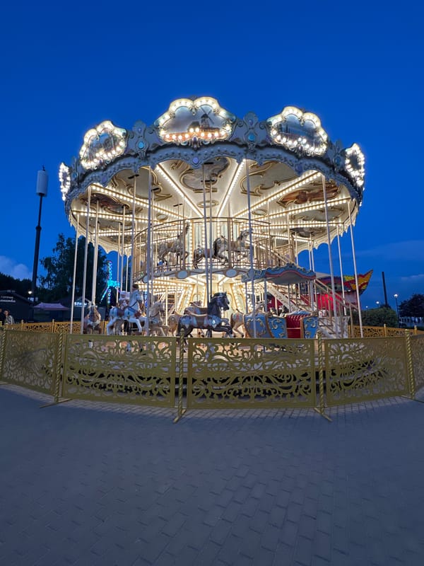 Ornate carousel spins at dusk in Novosibirsk