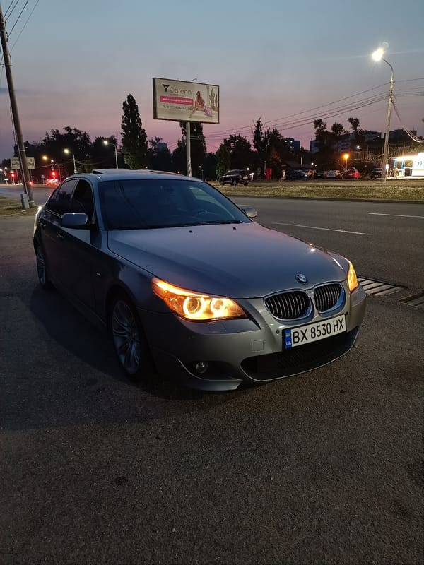 BMW 5 Series parked at dusk on Zaporizhzhia roadside