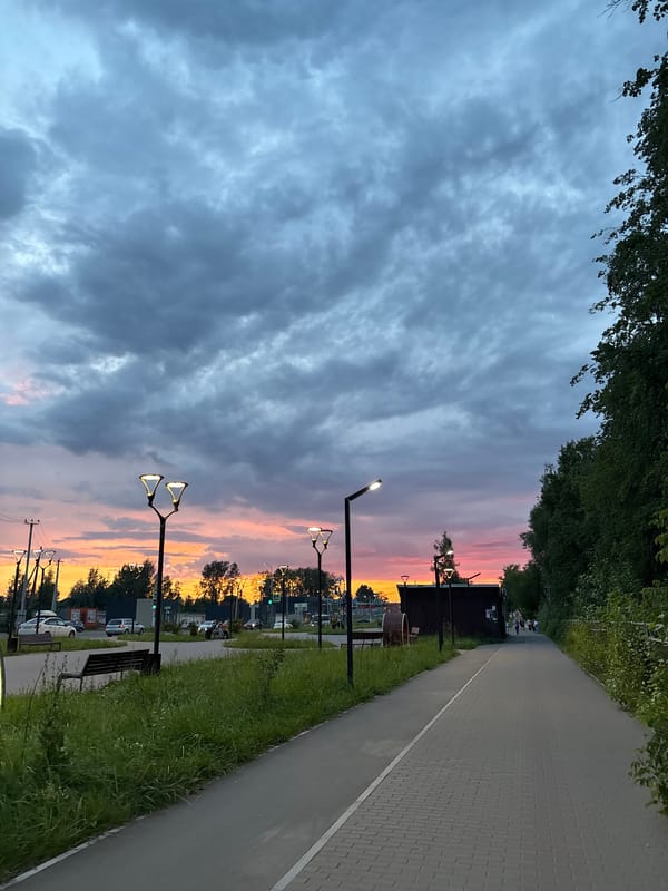 Sunset over a curved walkway as dusk settles in