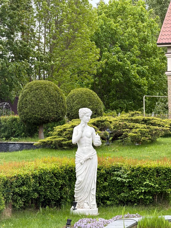 Classical marble statue observed in Strelna garden setting