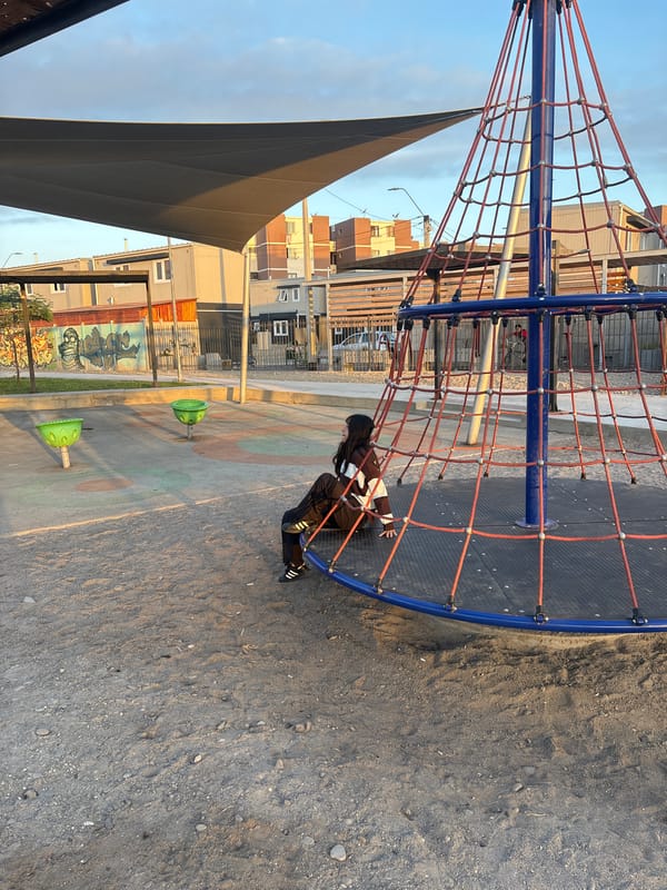 Child plays at Arica playground during golden hour sunset