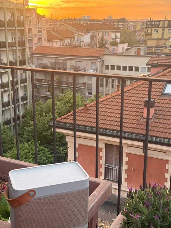 Evening balcony views capture Milan's rooftops during sunset
