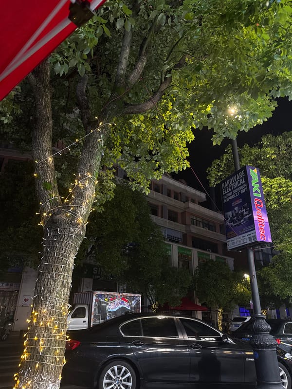 Rainy night exploring Yiwu's lit-up commercial streets