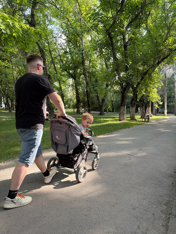 Busy park afternoon with families, walkers, and cyclists