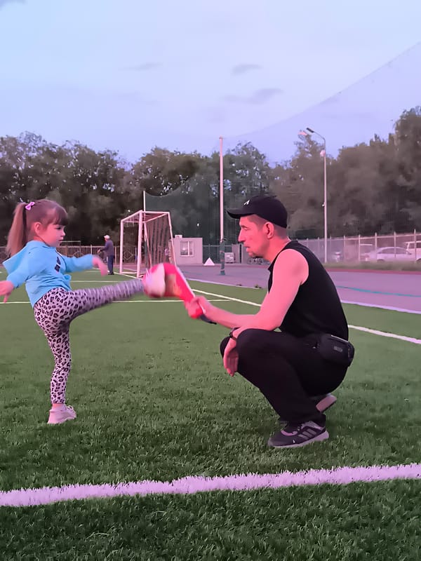 Martial arts drills at dusk on a Qarağandı sports field