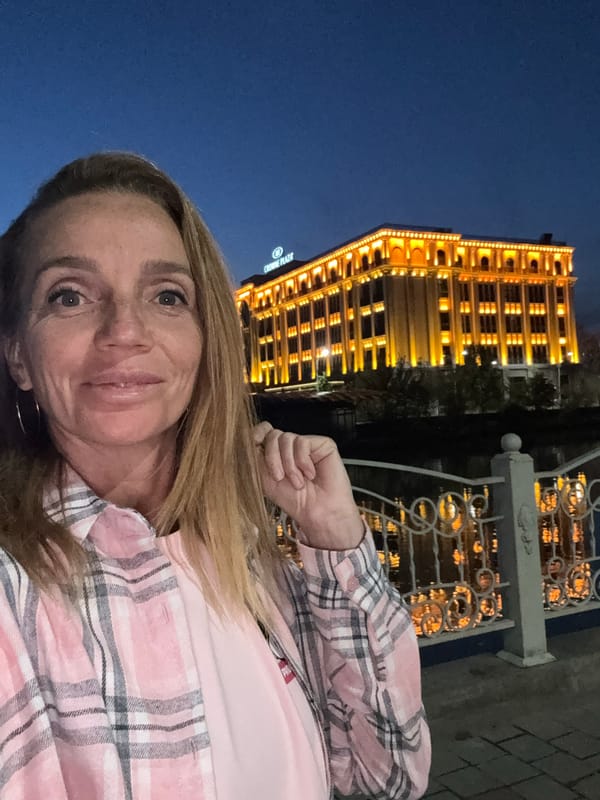 Nighttime scenes captured around illuminated Crowne Plaza Hotel in Tashkent