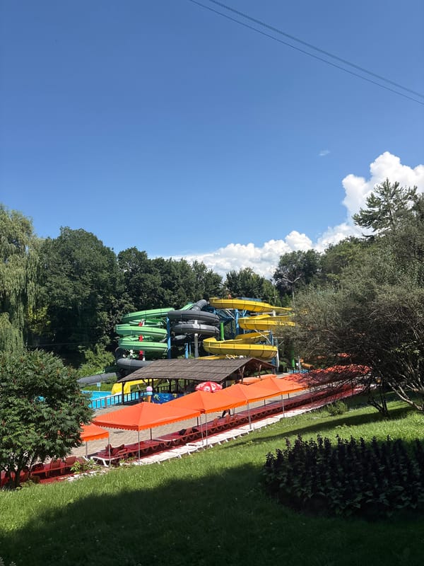 Summer water park day in Almaty with pools and slides