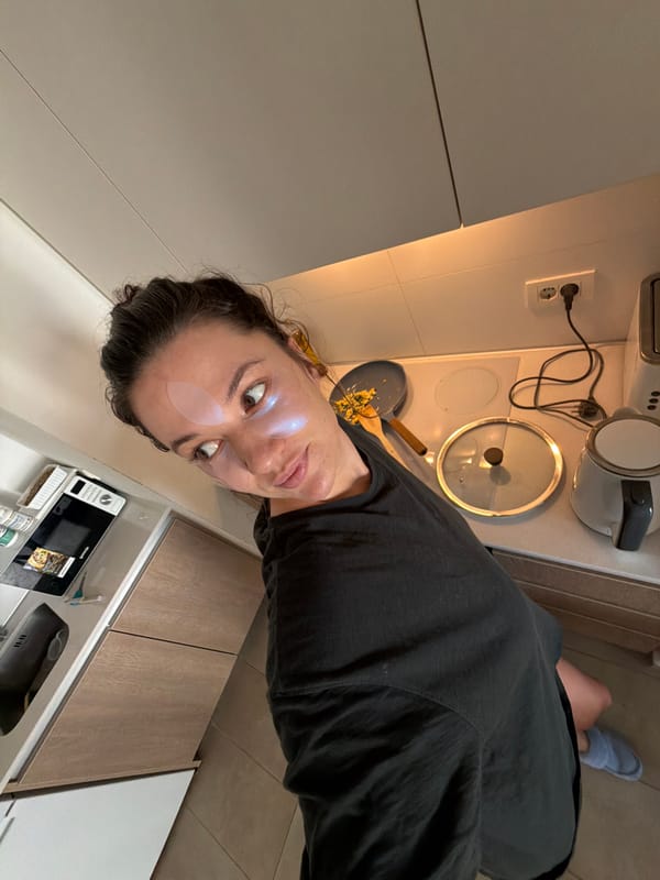 Woman multitasks cooking and selfie session in Belgrade kitchen