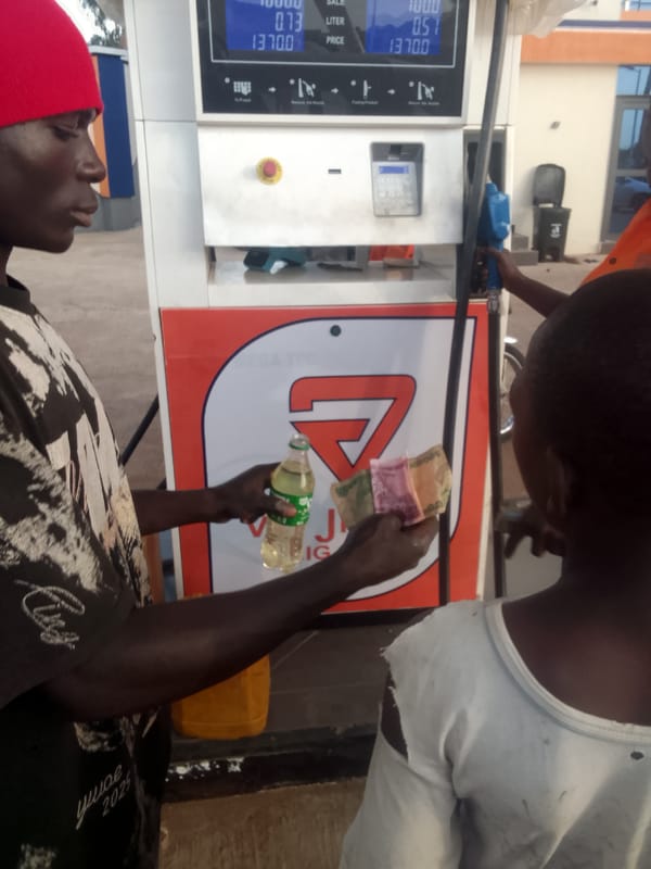 Man purchases fuel at Nigerian gas station
