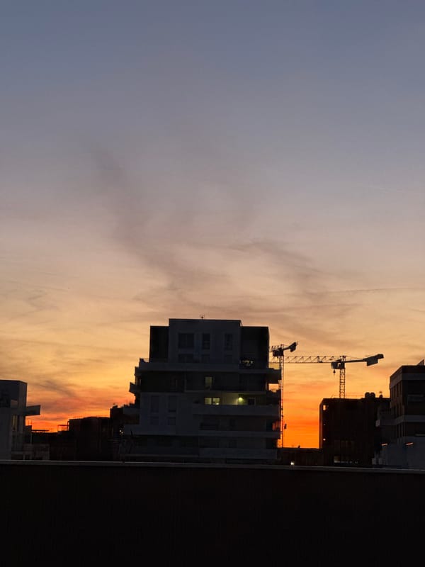 Sunset observed over Toulouse cityscape with contrails May 23