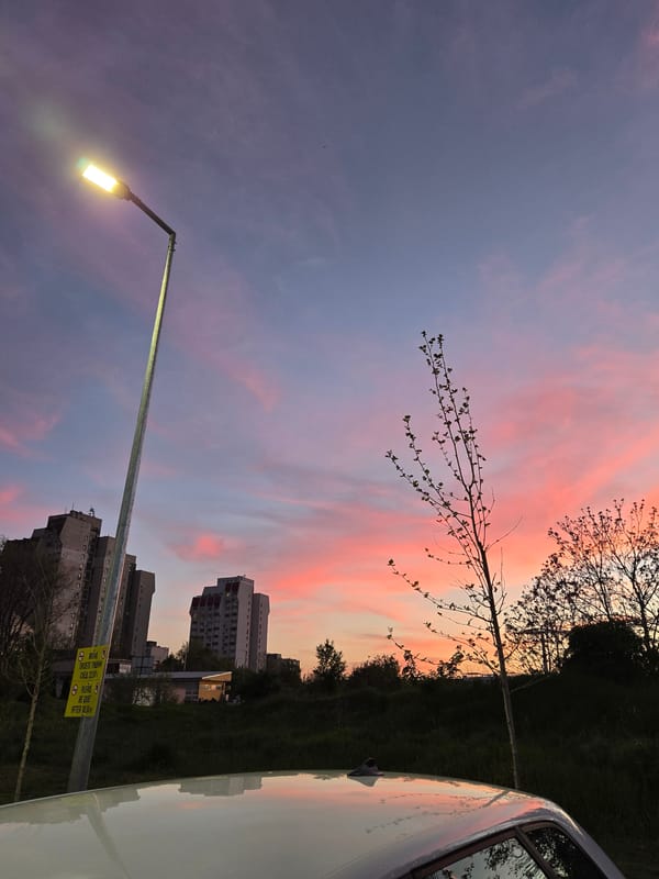 Urban sunset documented with dramatic sky colors and vehicle