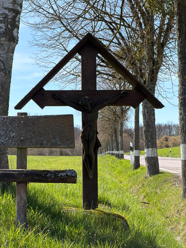 Roadside crucifix shrine documented in rural Junglinster, Luxembourg