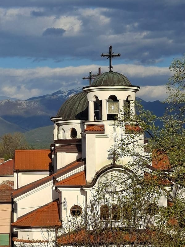White Orthodox church observed in urban setting