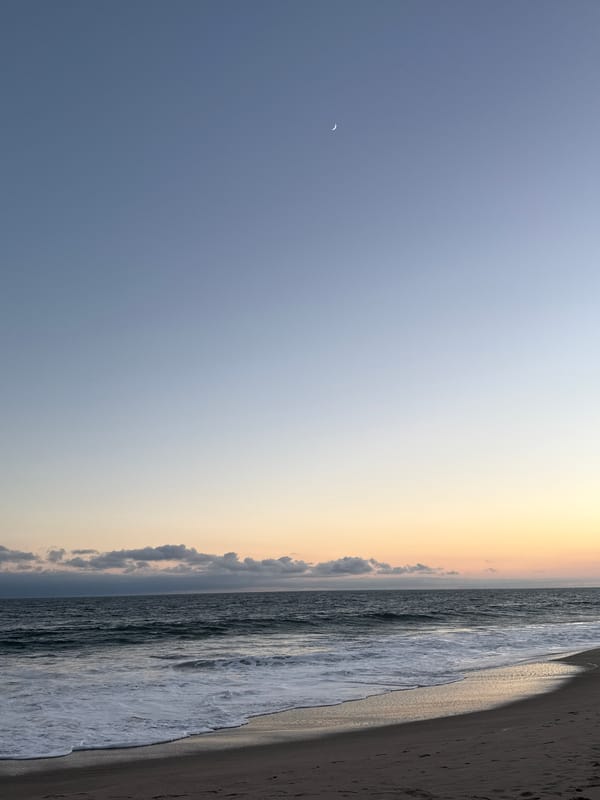 Sunset evening on a Malibu beach with people and waves