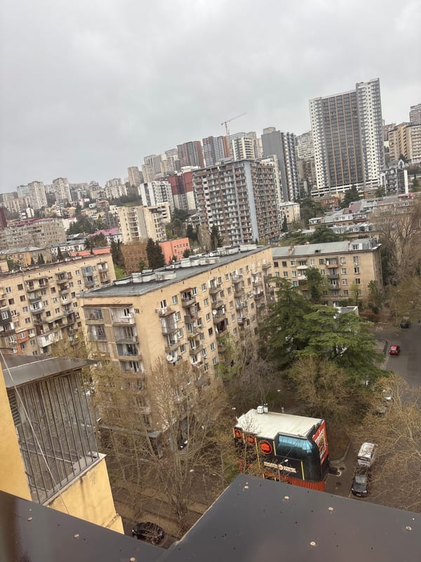 Early morning routine documented across Tbilisi apartment during rainy dawn