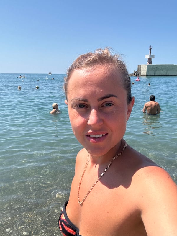 Crowded summer day on Sochi's Black Sea pebble beach