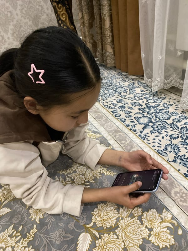 Girl with star hair clip views car on phone