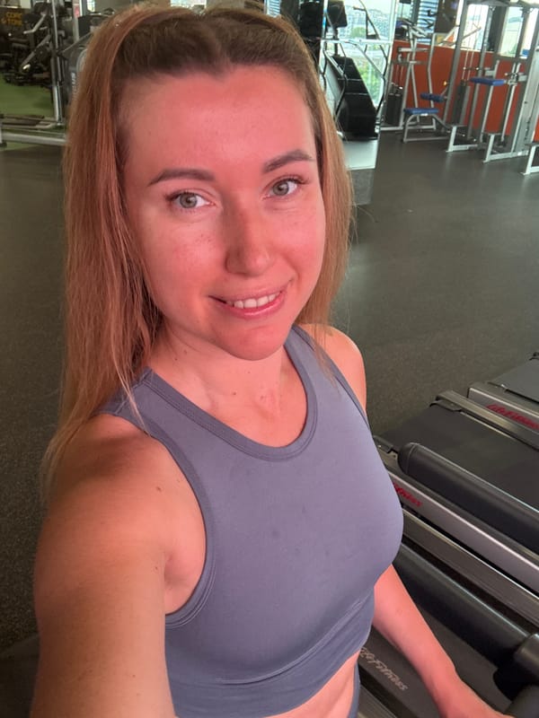 Woman documents morning gym workout session with selfies, treadmill use