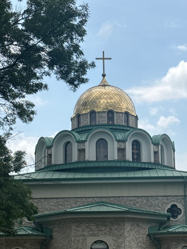 Woman photographed near golden-domed church in Burgas, Bulgaria