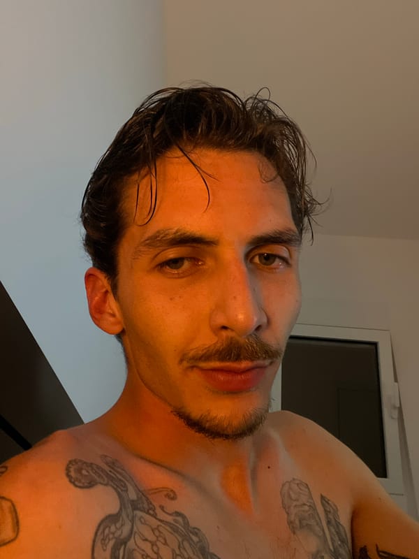 Man with wet hair and tattoos photographed in Rafailovići