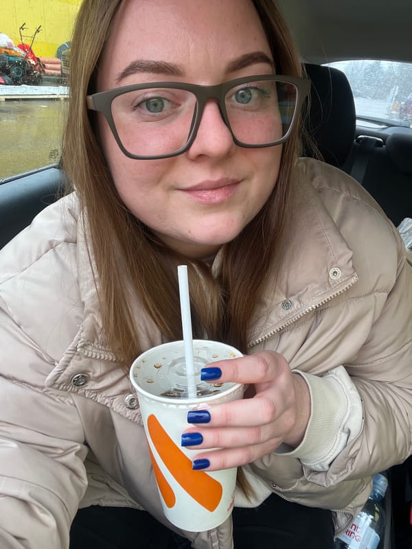 Woman takes selfies in car during rainy day